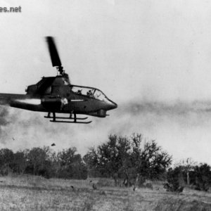 Huey Cobra Firing Rockets at Enemy Target
