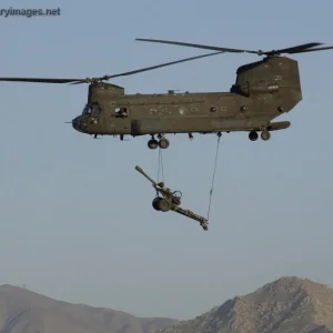 CH-47 Chinook helicopter transports an M119