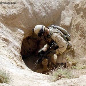 Soldier prepares to enter a cave