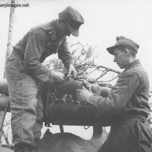 NCO at left is attaching the ignition device for the rocket