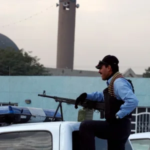 Iraqi police officer stands ready for a patrol