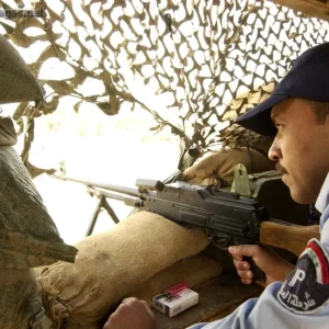 Iraqi policeman pulls security