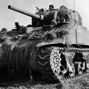 Sherman_tank_in_Vaucelles_France_ca_1944_Library_and_Archives_Canada_423312