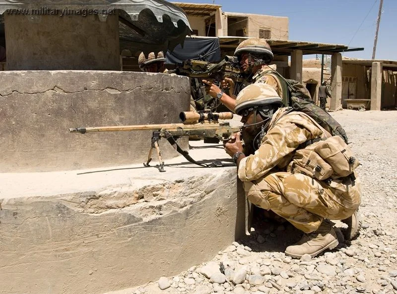 A sniper team watches the street