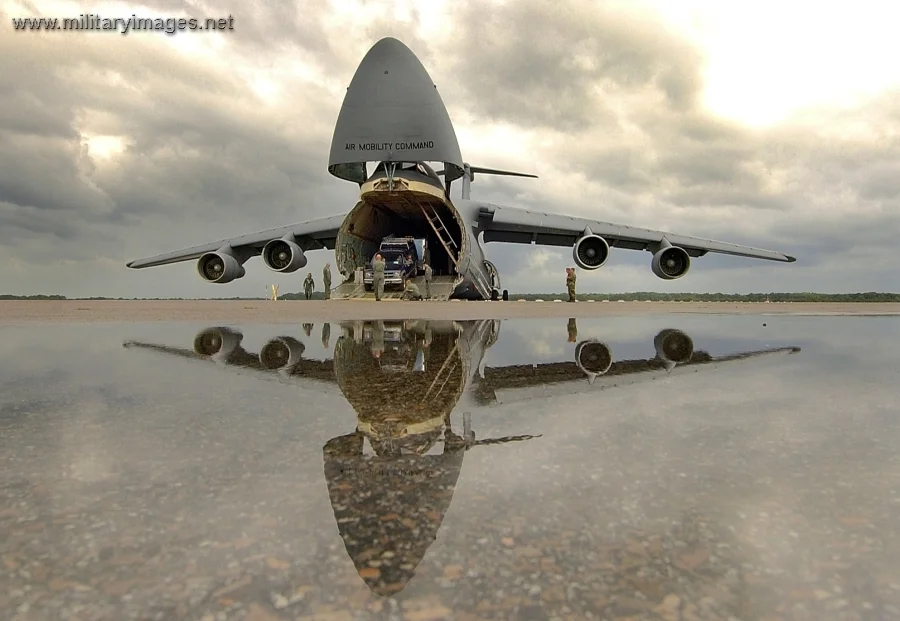 Airmen unload vehicles from a C-5 Galaxy