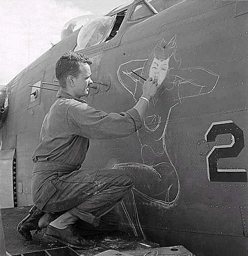 An airforce artist paints a bomber