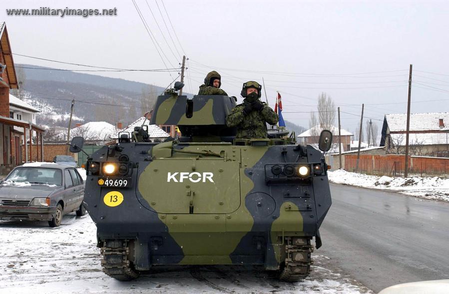 Danish vehicle patrolling village around Mitrovica