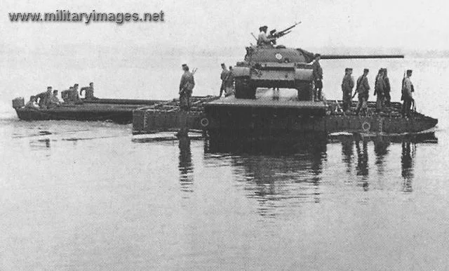 Engineers using ponttoon ferry to transport a tank