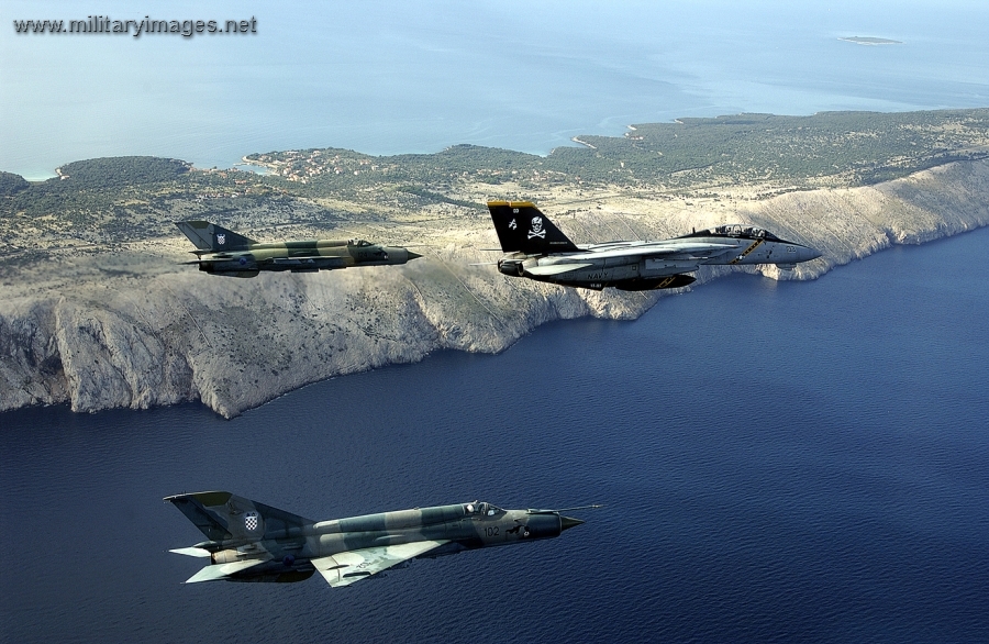 F-14B Tomcat flies in formation with a pair of MiG-21s