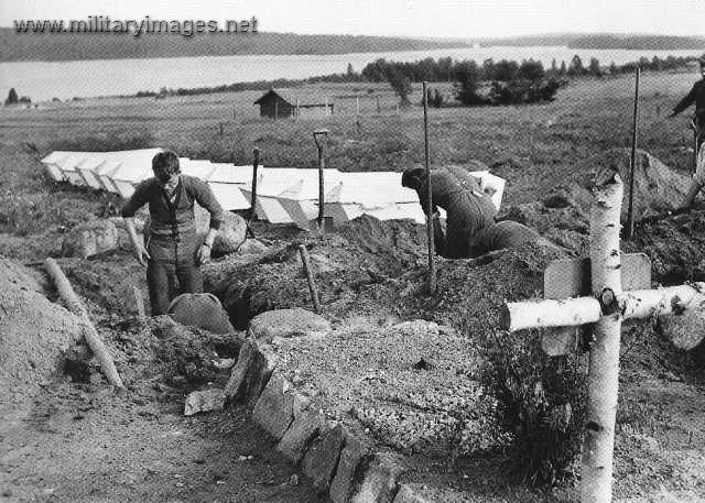 German soldiers from 163rd Division digging graves