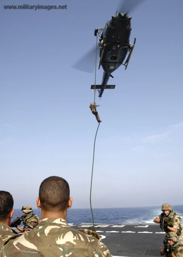 Italian Marine rappels from a AB-212 helicopter