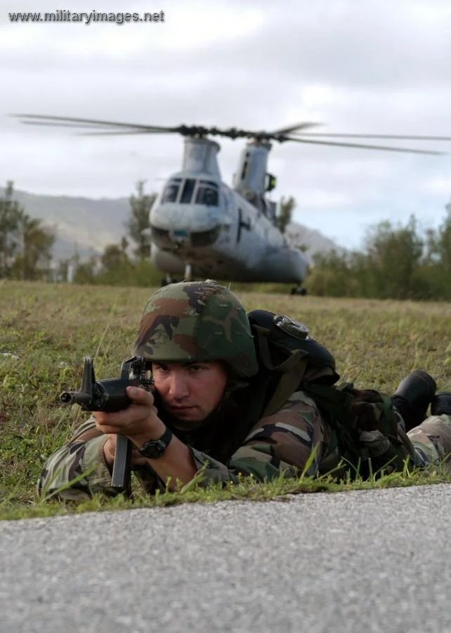 Marine Sgt. Donahoe guards a CH-46 Sea Knight