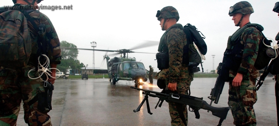 Marines prepare to board an Air Force HH-60G