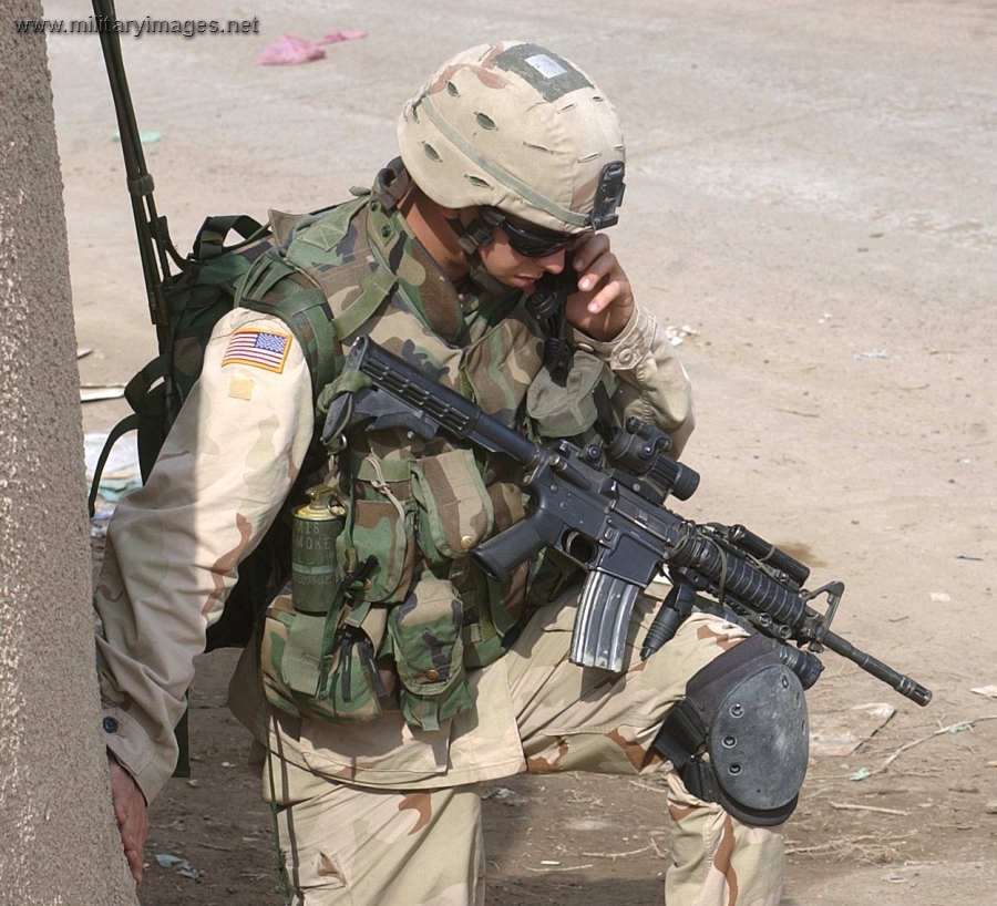 Paratrooper communicates through a tactical radio