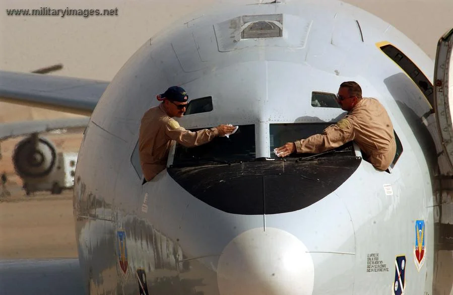 Pilots clean their windshield before taking off