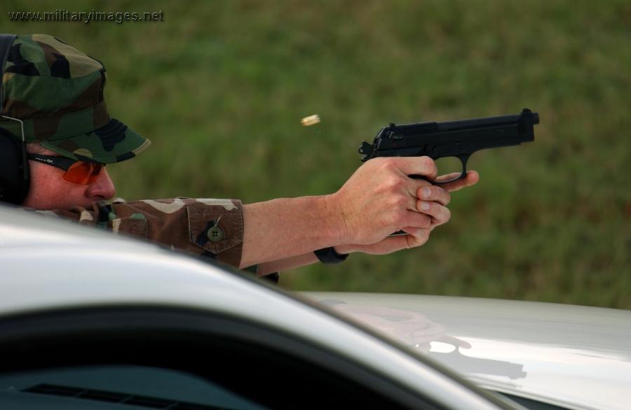 Senior Master Sergeant fires a 9 mm Beretta