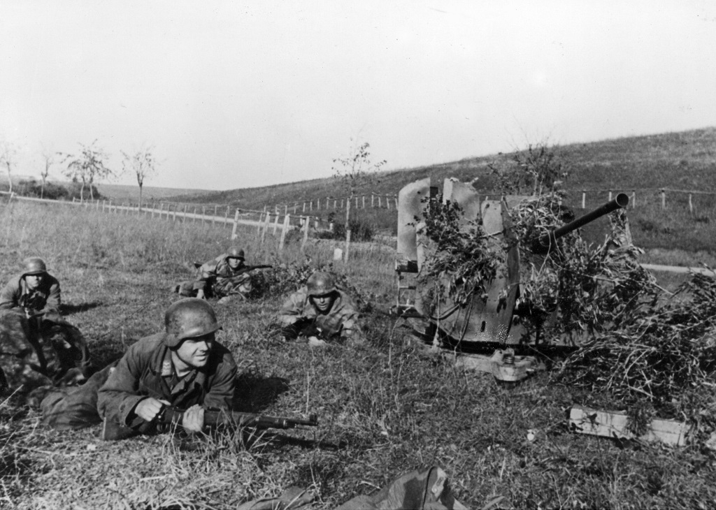 The Crew Of A 20mm Flak 38 Lay Prone Around Their Gun | A Military ...