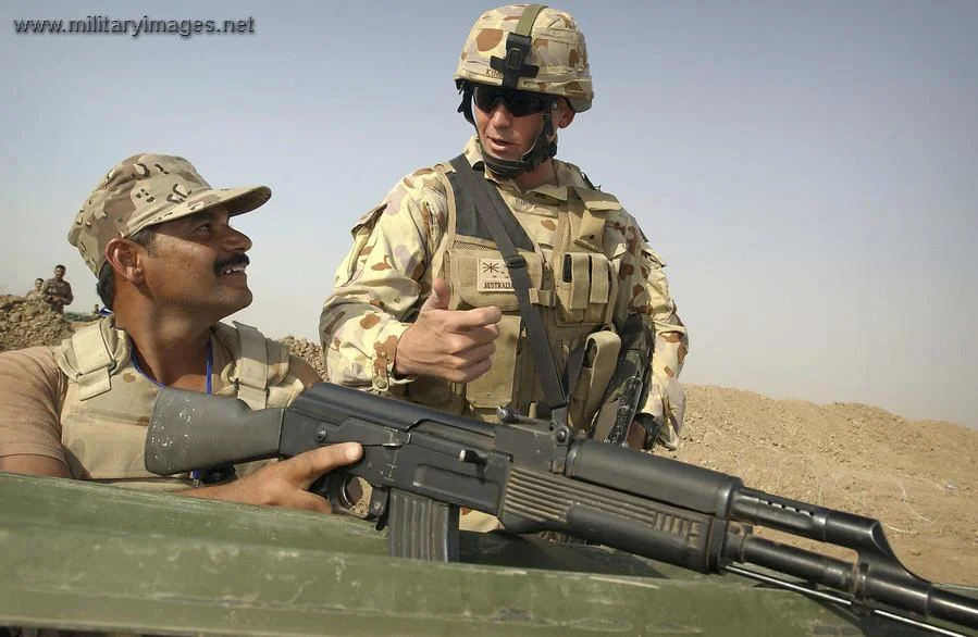 Warrant Officer watching over an Iraqi soldier